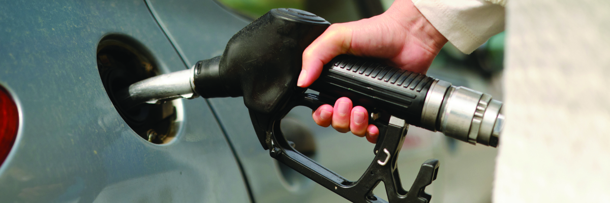 Hand on fuel pump filling up vehicle BANNER.jpg