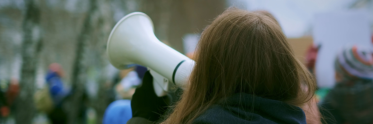 Strike megaphone back head white woman BANNER.jpg