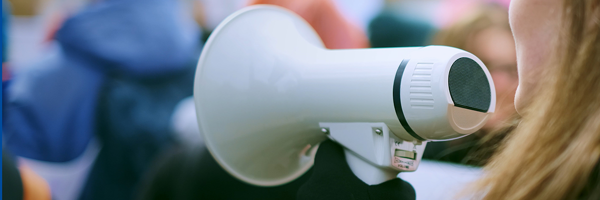 Strike megaphone partial face white woman BANNER.jpg