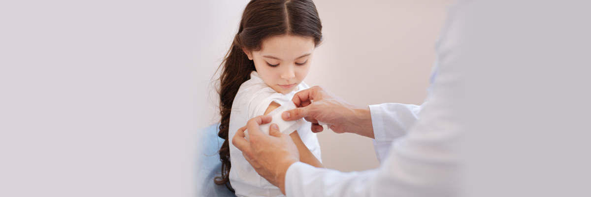 School Girl Getting Plaster on Arm