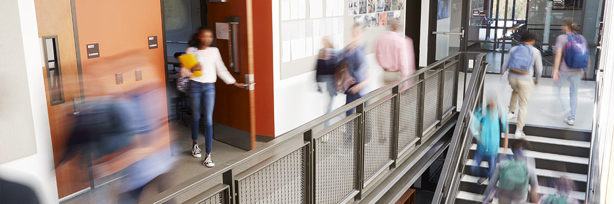 School corridor stairs students teachers blurred