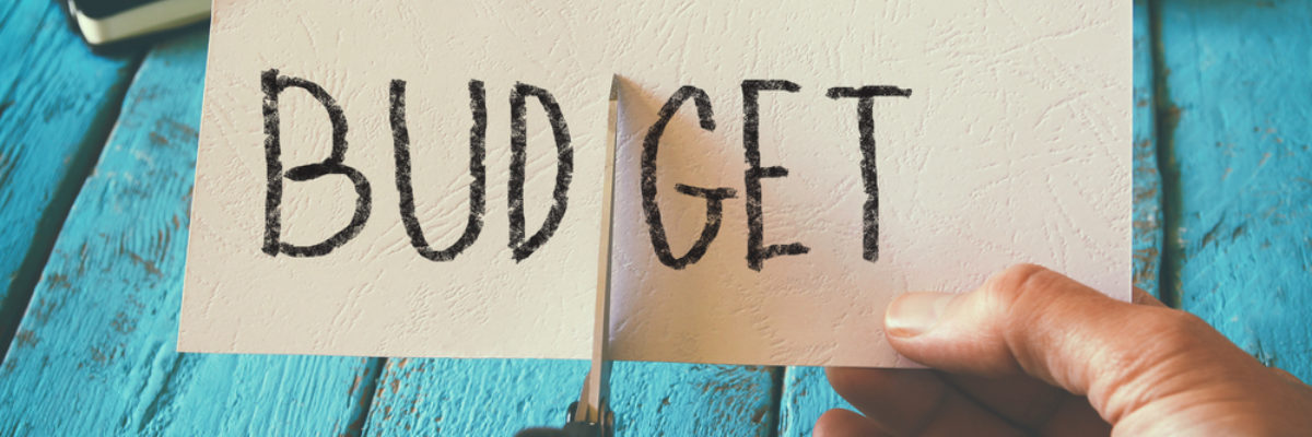 Budget funding cuts scissors