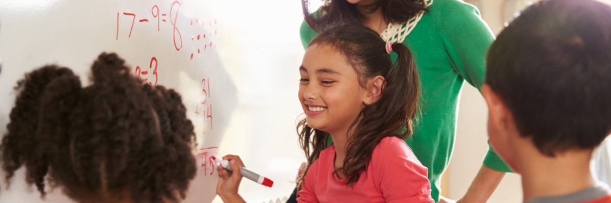 Mixed young children writing with Chinese female teacher