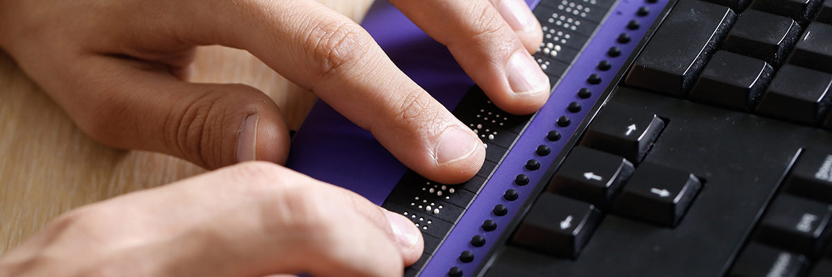Disabled white man Braille keyboard