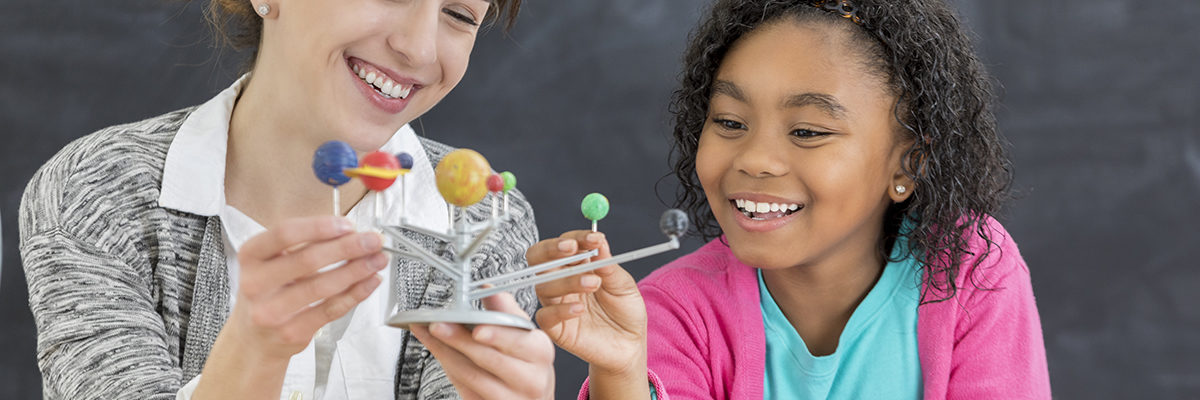 White female science teacher with black pupil