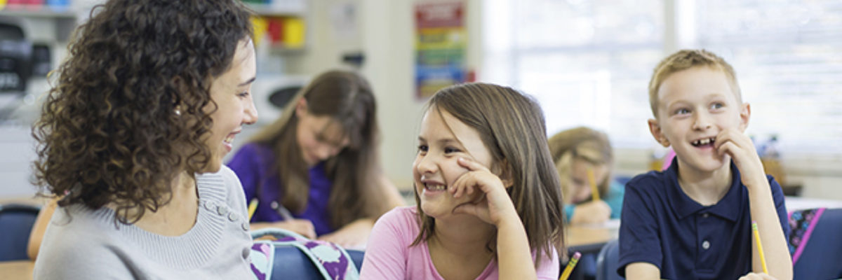 Mixed race female teacher white primary pupils