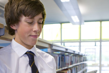 Secondary pupil library white boy