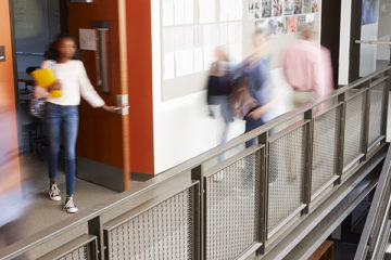 School corridor stairs students teachers blurred