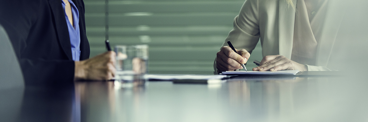White female teachers writing pen desk