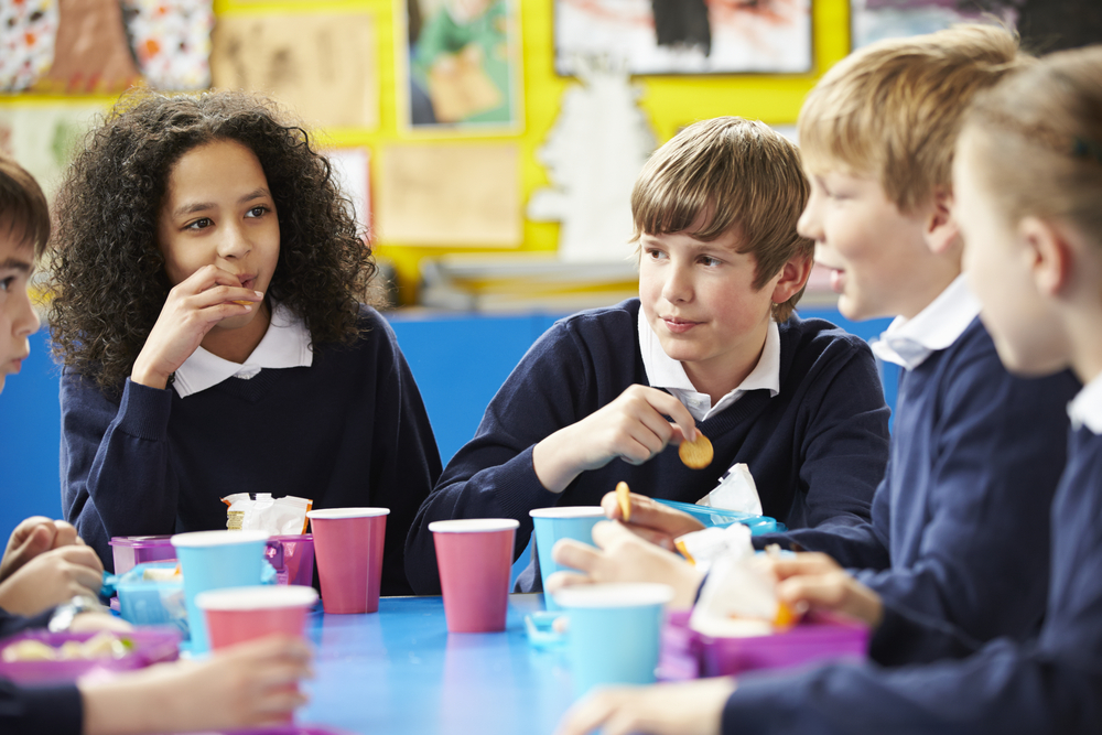 Mixed secondary pupils at lunch table